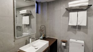A modern bathroom with a large mirror, a rectangular sink, a toilet, and a towel rack. - HongYi Home (Beijing)