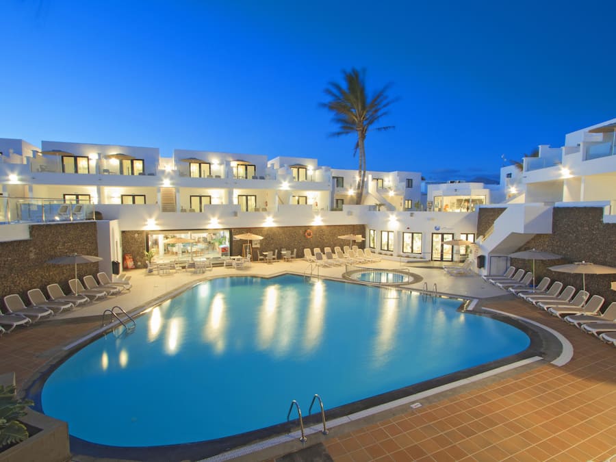 Een buitenzwembad, parasols voor strand/zwembad