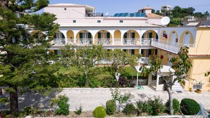 A multi-story building with balconies, a garden, and a satellite dish. - Domus Alta (Zakynthos)