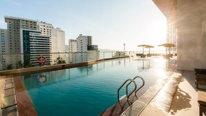 A rooftop pool with clear views of surrounding buildings, a lifebuoy, and sunlit surroundings. - Muong Thanh Luxury Vien Trieu Hotel (Bac Nha Trang)