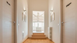 A hallway with wooden flooring, white walls, and doors labeled "Motel" and "Hotel." - Agriturismo Masseria Cannella (Poggio Imperiale)