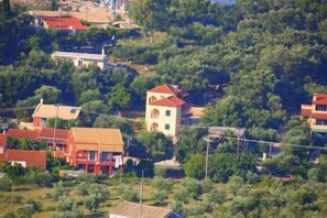 A residential area with houses surrounded by dense greenery. - Emily's Apartments (Corfu)