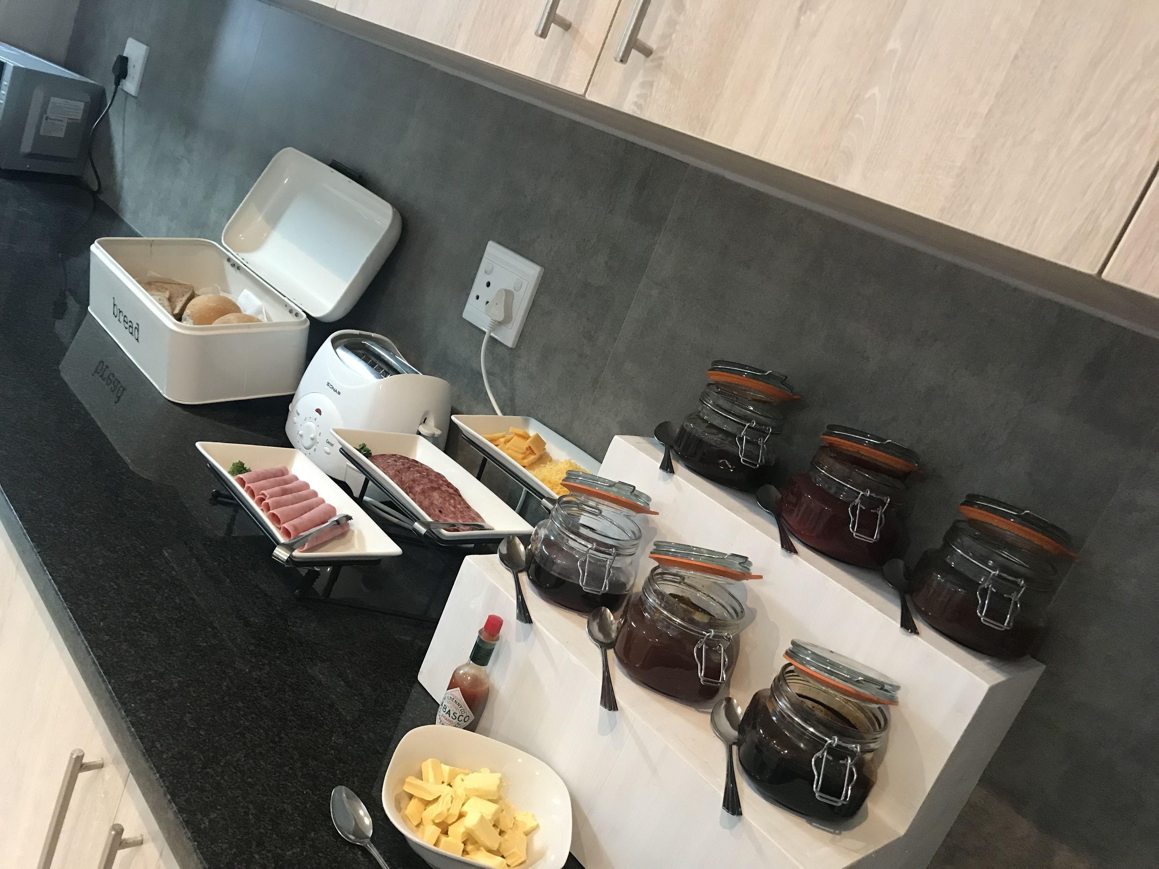 A breakfast buffet with various food items and condiments.