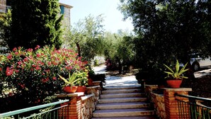 A staircase leading to a building with a brick wall and metal railings. - Casa del sole, breathtaking view of the Pontine islands and the Circeo (Sperlonga)