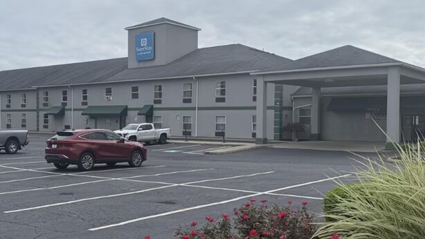A large building with a parking lot, a covered area, and a sign indicating it is a SureStay hotel. - Surestay Best Western Obetz Rickenbacker Airport (Columbus)