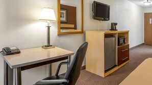 A hotel room with a desk, chair, lamp, television, minibar, and a bed. - Surestay Best Western Obetz Rickenbacker Airport (Columbus)