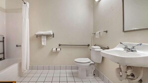 Een badkamer met een bad, toilet en wastafel.