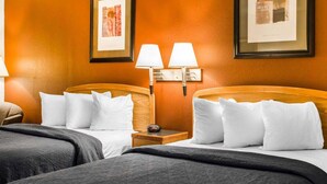 A hotel room with two beds, each with white bedding and a wooden headboard. There are two wall-mounted lamps on either side of the room. - Surestay Best Western Obetz Rickenbacker Airport (Columbus)
