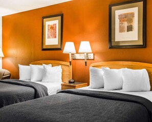 A hotel room with two beds, each with white bedding and a wooden headboard. There are two wall-mounted lamps on either side of the room. - Surestay Best Western Obetz Rickenbacker Airport (Columbus)
