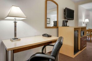 A hotel room with a desk, chair, lamp, telephone, television, and a microwave. - Surestay Best Western Obetz Rickenbacker Airport (Columbus)