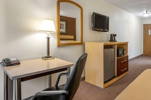 A hotel room with a desk, chair, lamp, television, minibar, and a bed. - Surestay Best Western Obetz Rickenbacker Airport (Columbus)