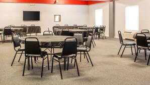 A conference room with multiple tables and chairs, a flat-screen TV, and a large window. - Surestay Best Western Obetz Rickenbacker Airport (Columbus)