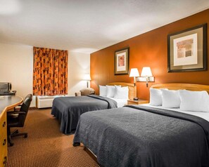 A hotel room with two beds, a desk with a chair, a television, and a patterned curtain. - Surestay Best Western Obetz Rickenbacker Airport (Columbus)