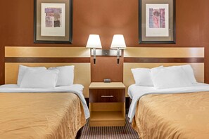 A hotel room with two beds, a nightstand with a lamp, and framed artwork on the wall. - Surestay Best Western Obetz Rickenbacker Airport (Columbus)