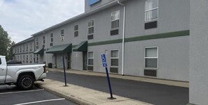 A building with a parking lot, a white pickup truck, and a blue handicapped parking sign. - Surestay Best Western Obetz Rickenbacker Airport (Columbus)