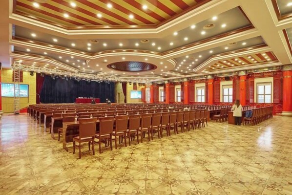 A large hall with rows of chairs and a stage, likely for events or conferences. - Jinxiu Hotel (Shanghai)