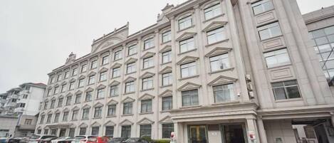 A multi-story hotel with a symmetrical facade, large windows, and a central entrance.