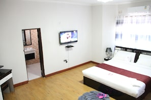 Standard Double Room | Minibar, in-room safe, desk, blackout curtains