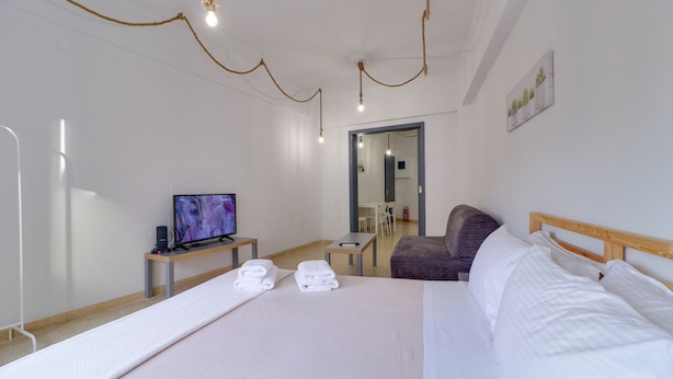 A hotel room with a bed, a TV, a desk, and a chair. - athens.apartotel.2 (Athens)