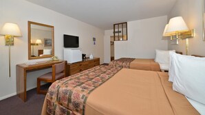 A hotel room with a desk, two beds, a television, and a mirror. - Americas Best Value Inn (North Platte)