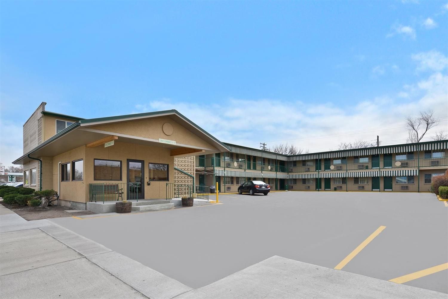A motel with a single-story building and a two-story parking garage.