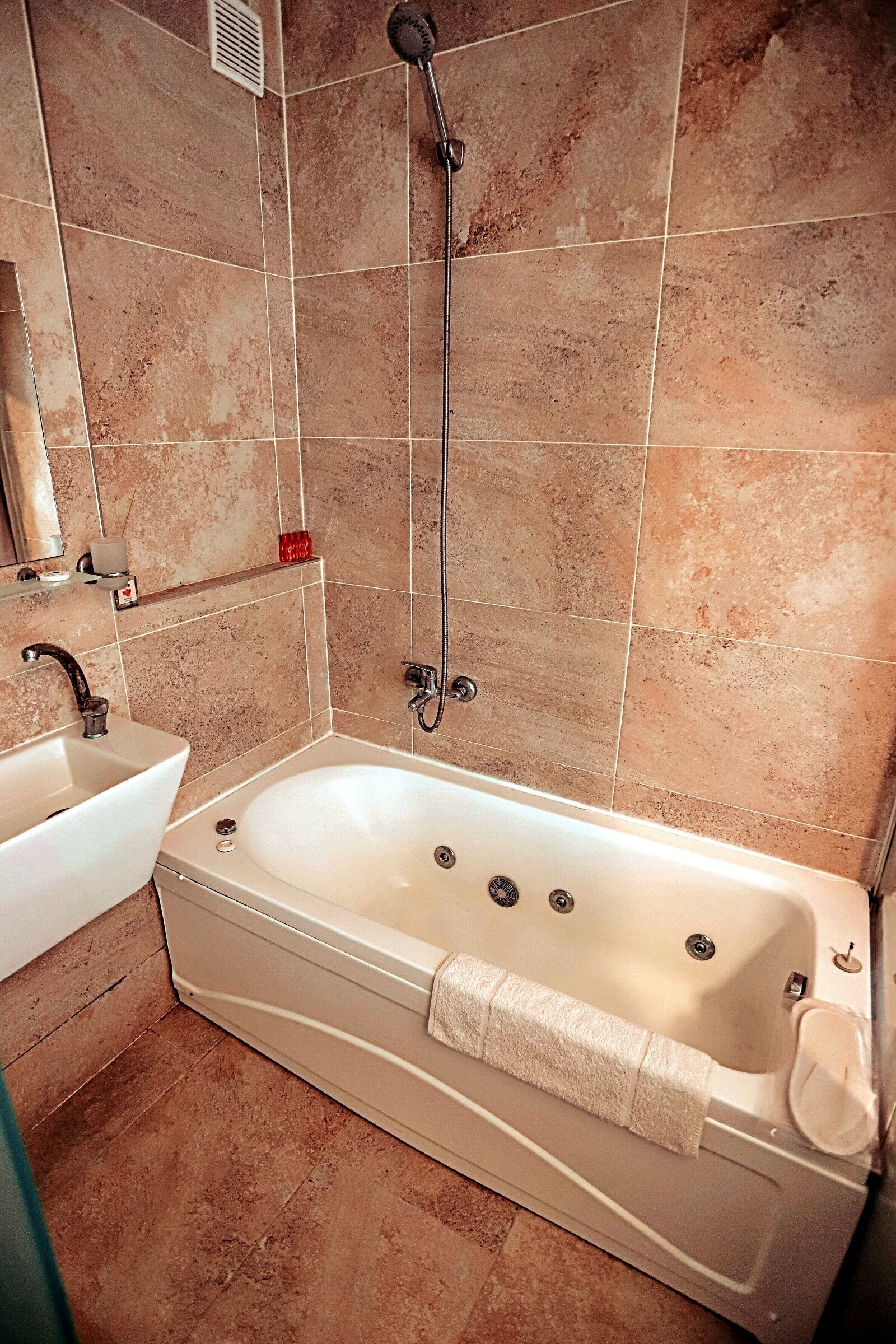 A bathroom with a bathtub, a sink, and a shower.