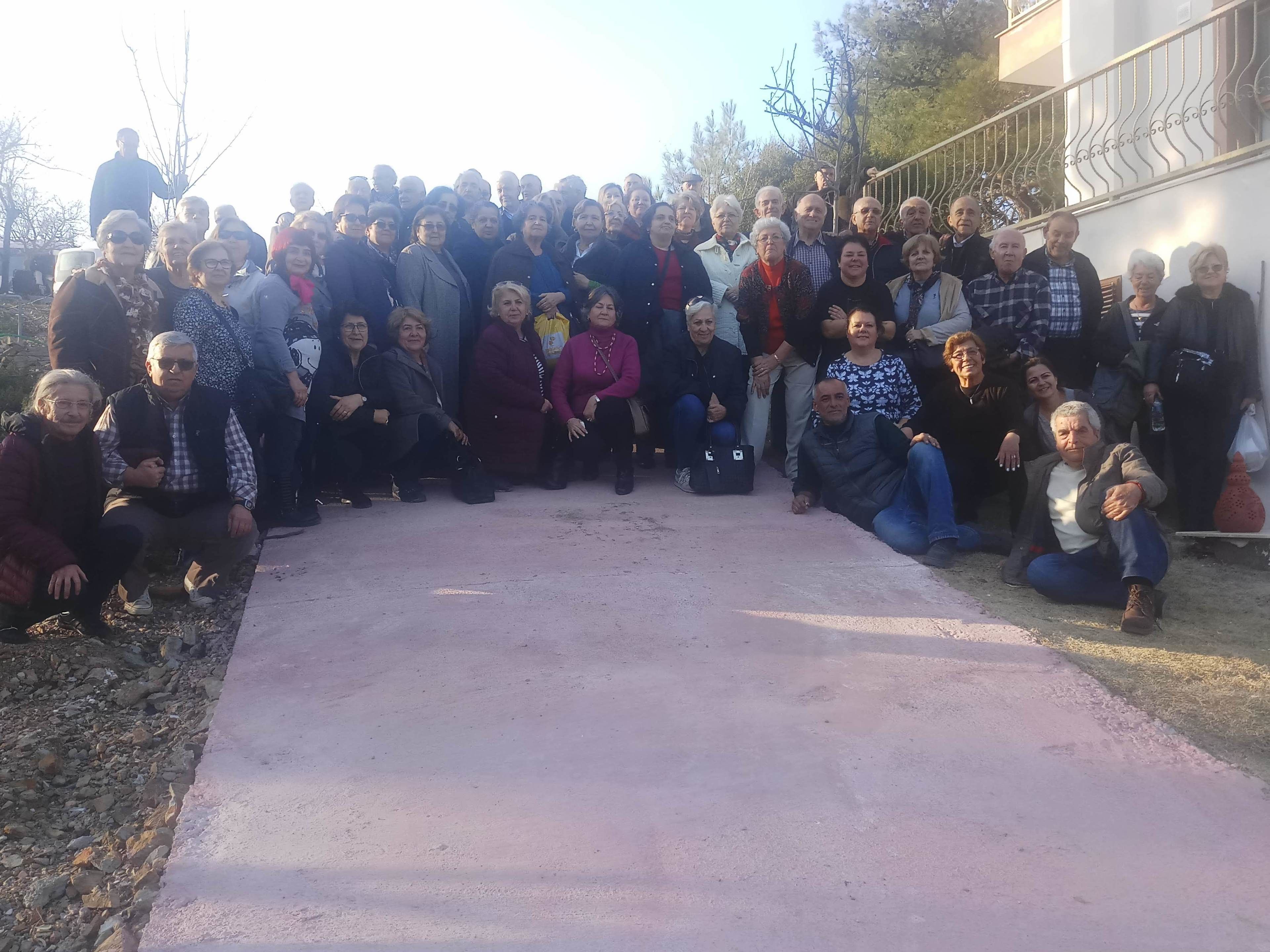 A group of people gathered outdoors, possibly for an event or meeting.