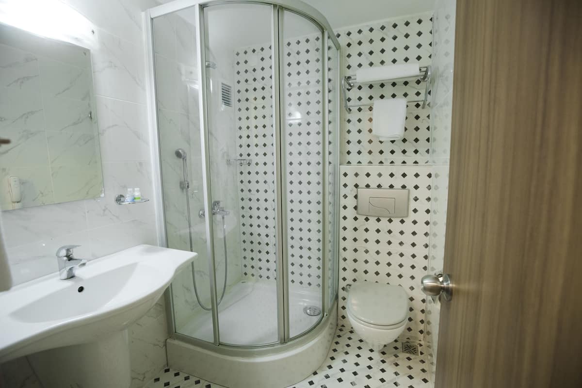 shower, hair dryer, slippers, towels