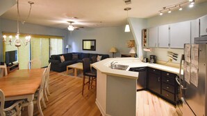 Un espace de vie compact comprenant un coin repas, une kitchenette et un canapé.