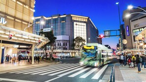 A modern building with a glass facade and signage for "Tokai Yamato."