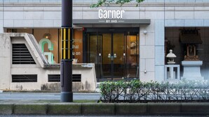 A building with a storefront labeled "Garnier BY IHG."