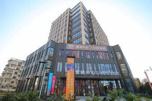 A multi-story building with a prominent entrance and signage.