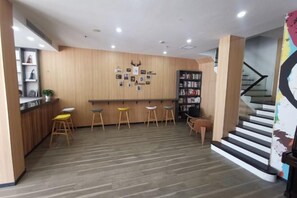 A modern interior with a bar area, wooden flooring, and a staircase. - OK Boutique Hotel (Shanghai)