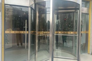 A revolving door with glass panels and a yellow safety line. - OK Boutique Hotel (Shanghai)