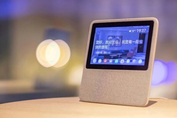 A tablet on a stand displaying a room with a bed, a chair, and a table. - Orange Hotel (Shanghai Jiaotong University, Jiangchuan Road Metro Station) (Shanghai)
