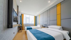 A hotel room with two beds, a TV mounted on the wall, a desk, and a window with curtains. - OTA short name: Mingyang Hotel (Taiyuan South Railway Station · Shanxi University Branch) (Taiyuan)