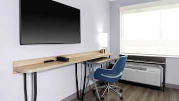 A modern office space with a desk, chair, and a large blackboard.