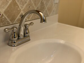 A bathroom sink with a chrome faucet and a single-handle design. - "The Richard" 3BR Lakefront: 60-Ac Estate Access with Private Beach sleeps 8 (Irving)
