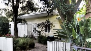 A residential property with a gated entrance, a mailbox, and a pathway leading to the house. - Retro Beach House on Pearl Beach (Pearl Beach)