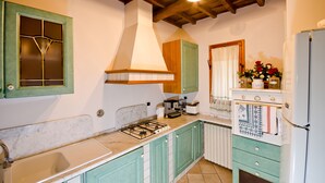 A kitchen with a gas stove, a coffee maker, and a refrigerator. - || NEW Incredible View || Piazza della Signoria apt! (Firenze)