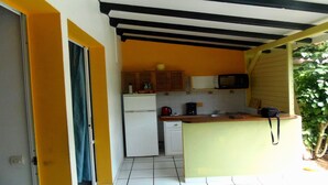 A compact kitchen with a refrigerator, microwave, and coffee maker.