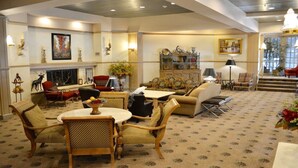 A spacious lounge with a fireplace, comfortable seating, and a bookshelf. - LUXURIOUS AND SPACIOUS CONDO ,SKI IN/ SKI OUT IN BEAVER CREEK, COLORADO. (Avon)