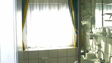 Ein Badezimmer mit Toilette, Waschbecken und Duschbereich.