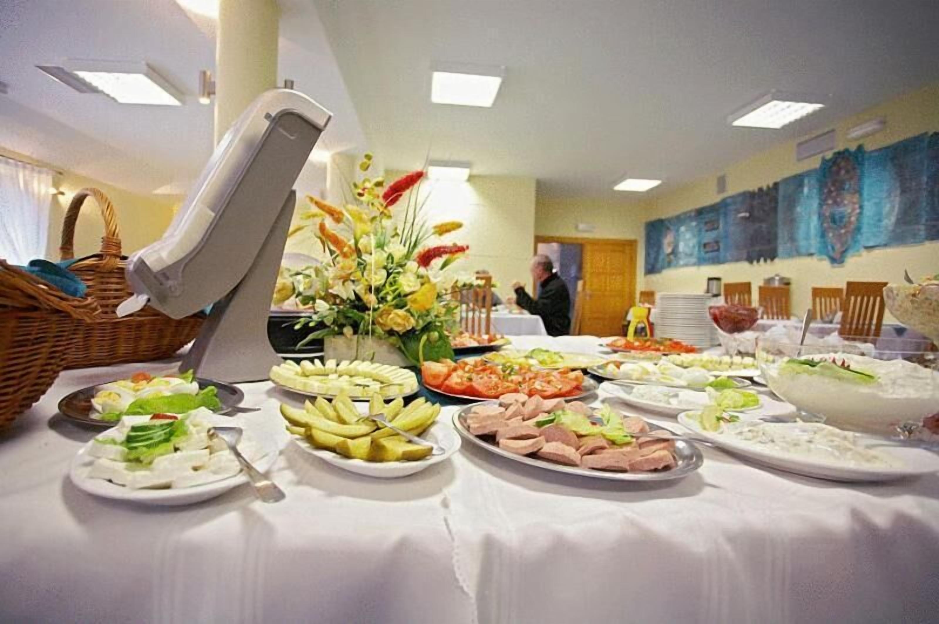 A buffet table with various food items and a decorative centerpiece.