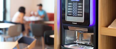 A coffee machine with a digital interface and a water dispenser.