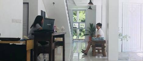 Amplia sala de estar con techo alto, una mesa de comedor y un sofá.