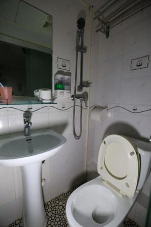 A bathroom with a sink, toilet, and shower. - Everest Hostel Block E (Kowloon)