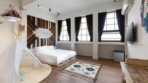 A modern bedroom with a bed, a white canopy tent, a patterned rug, and a large window with curtains. - You Worth Inn (Hualien City)