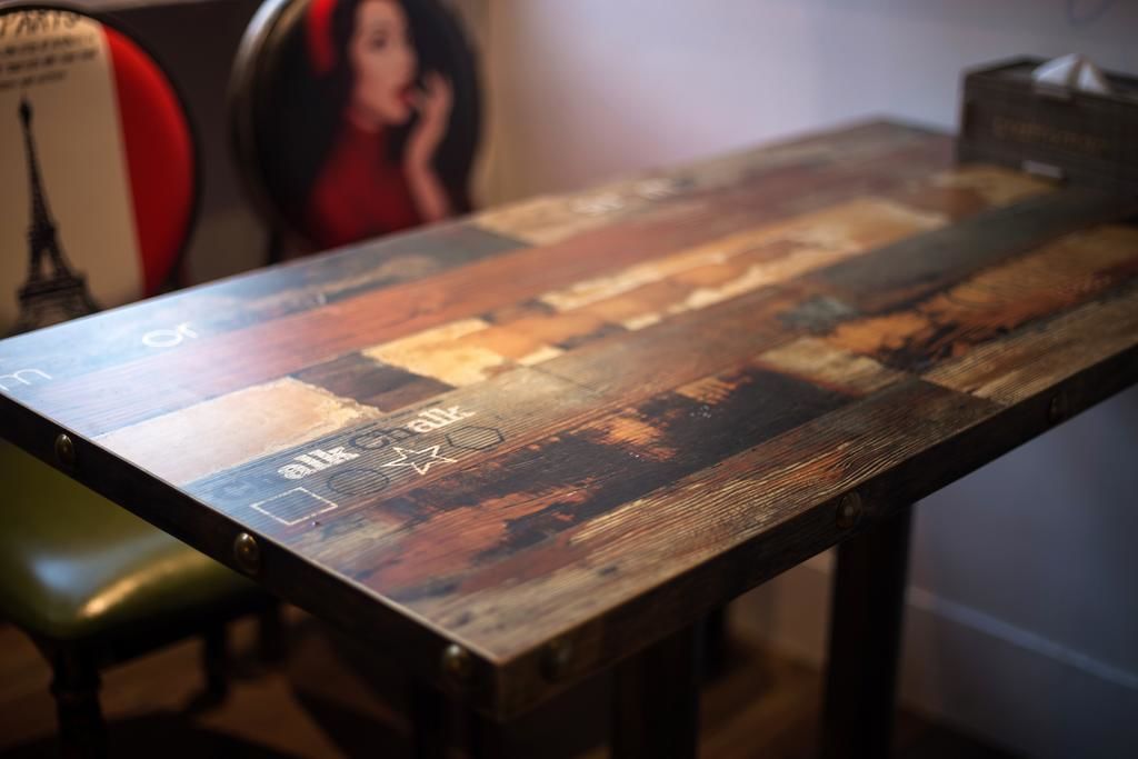 A wooden table with a vintage design, featuring a map and various icons.