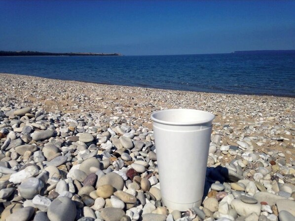 Enjoy a serene beach experience with a clear view of the sea.